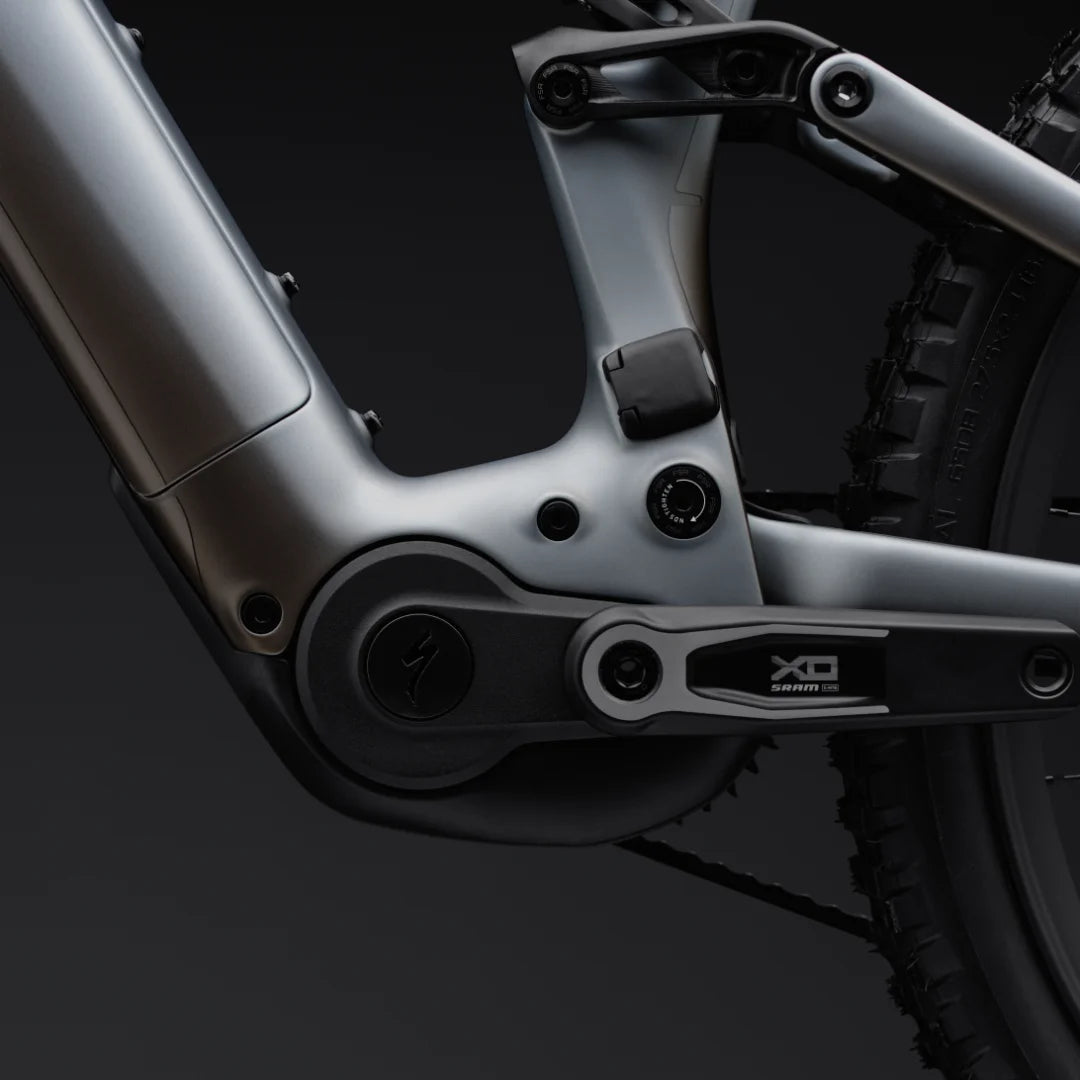 Close-up of a bicycle suspension fork with 'XO' branding on a dark background